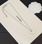 Silver-tone dual chain necklace with heart pendant and small logo charm