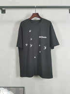 Dark crewneck T-shirt with bird icon graphic and McQueen logo print