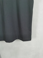 Dark crewneck T-shirt hem detail, plain fabric