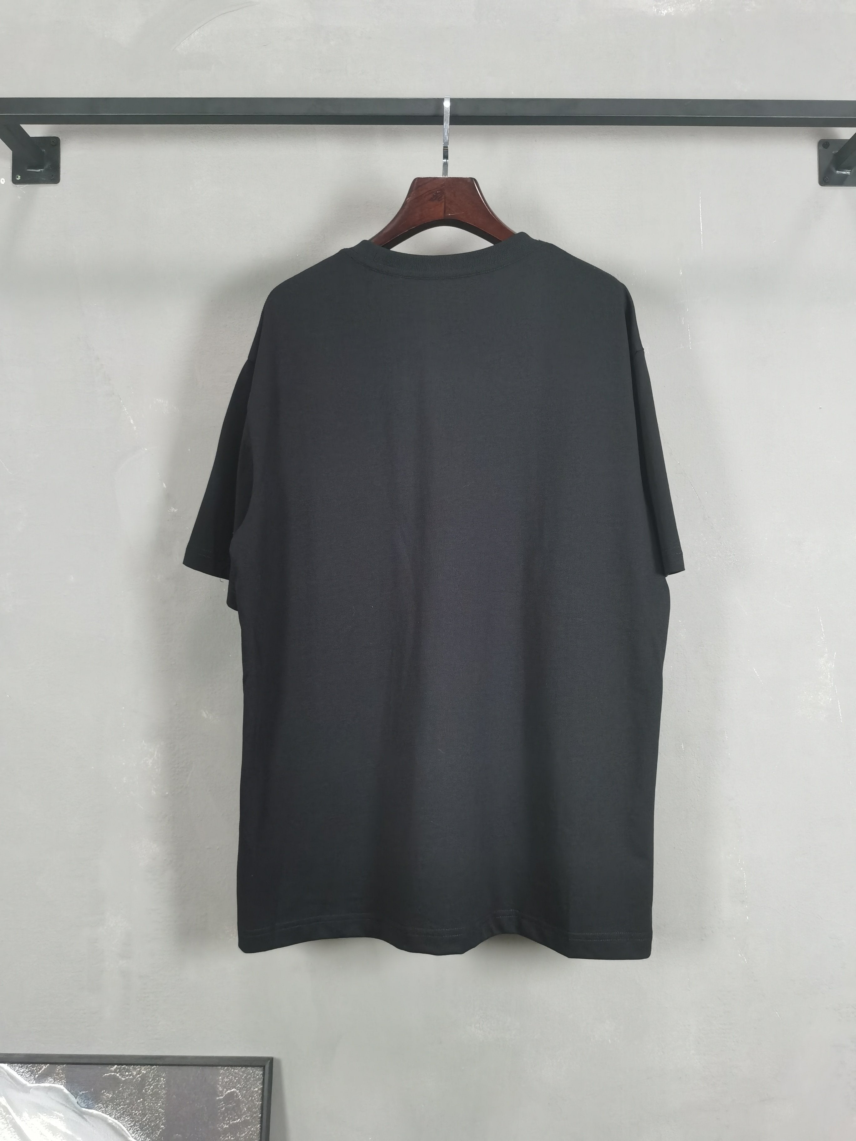 Dark crewneck T-shirt shown from the back, plain design