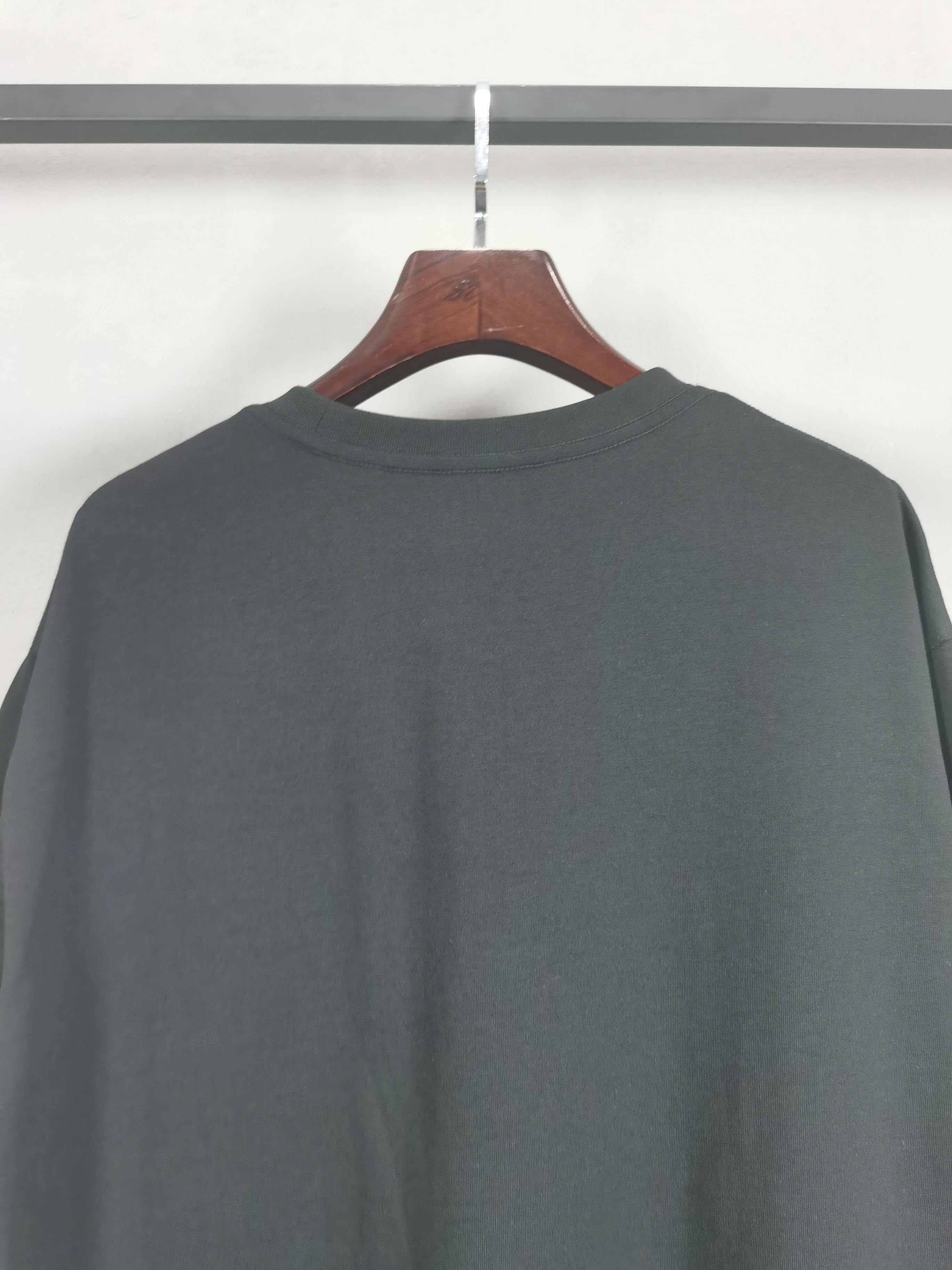 Dark crewneck T-shirt back view with round neckline, no front graphics