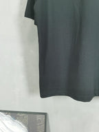 Dark crewneck T-shirt back view with straight hem and no visible graphics