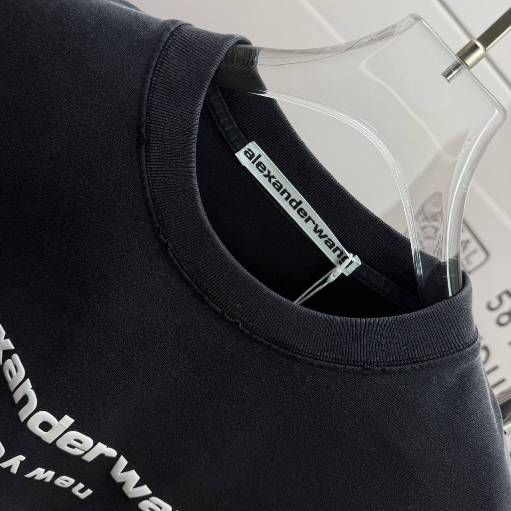 Crewneck collar of a dark black short-sleeve T-shirt with alexanderwang inside label