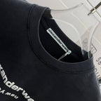 Crewneck collar of a dark black short-sleeve T-shirt with alexanderwang inside label