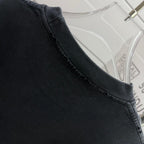 Neckline and shoulder seam of a dark black short-sleeve T-shirt