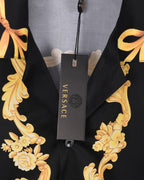 Black shirt with gold floral scroll print and VERSACE hang tag on neckline