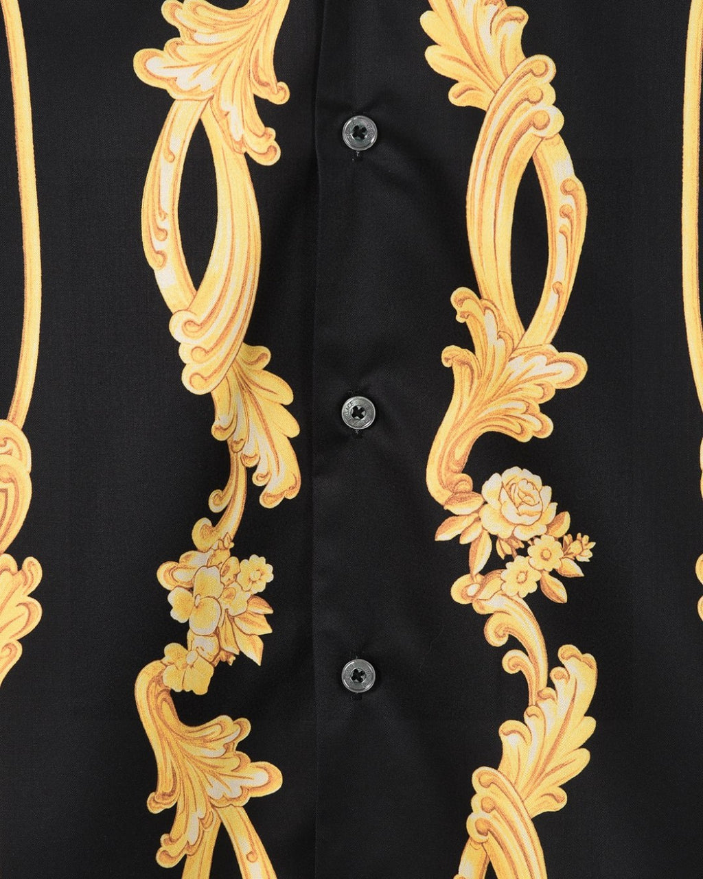 Black shirt front close-up with gold floral scrolls and visible button placket