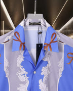 Versace short-sleeve button-up shirt on hanger, blue and white baroque print, tag visible