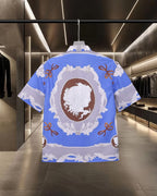Versace short-sleeve button-up shirt, blue with white back emblem and orange bow accents