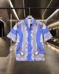 Versace short-sleeve button-up shirt, blue with white baroque print and orange bows
