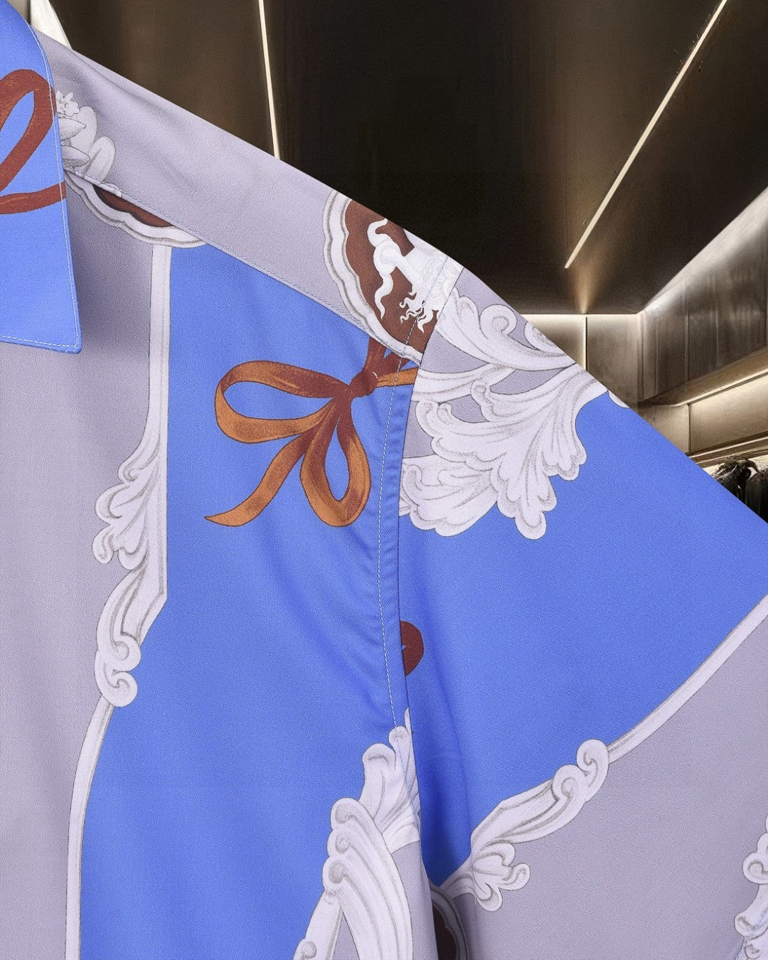Versace short-sleeve button-up shirt, sleeve with white baroque scrollwork and orange bows