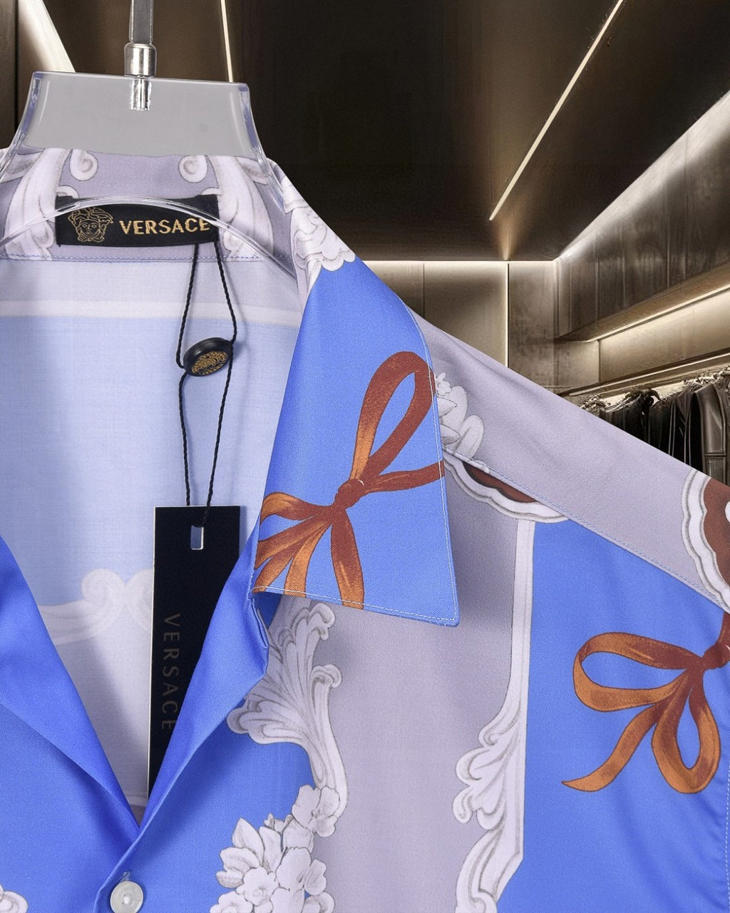 Versace short-sleeve button-up shirt shoulder detail, blue/white panels with orange bows