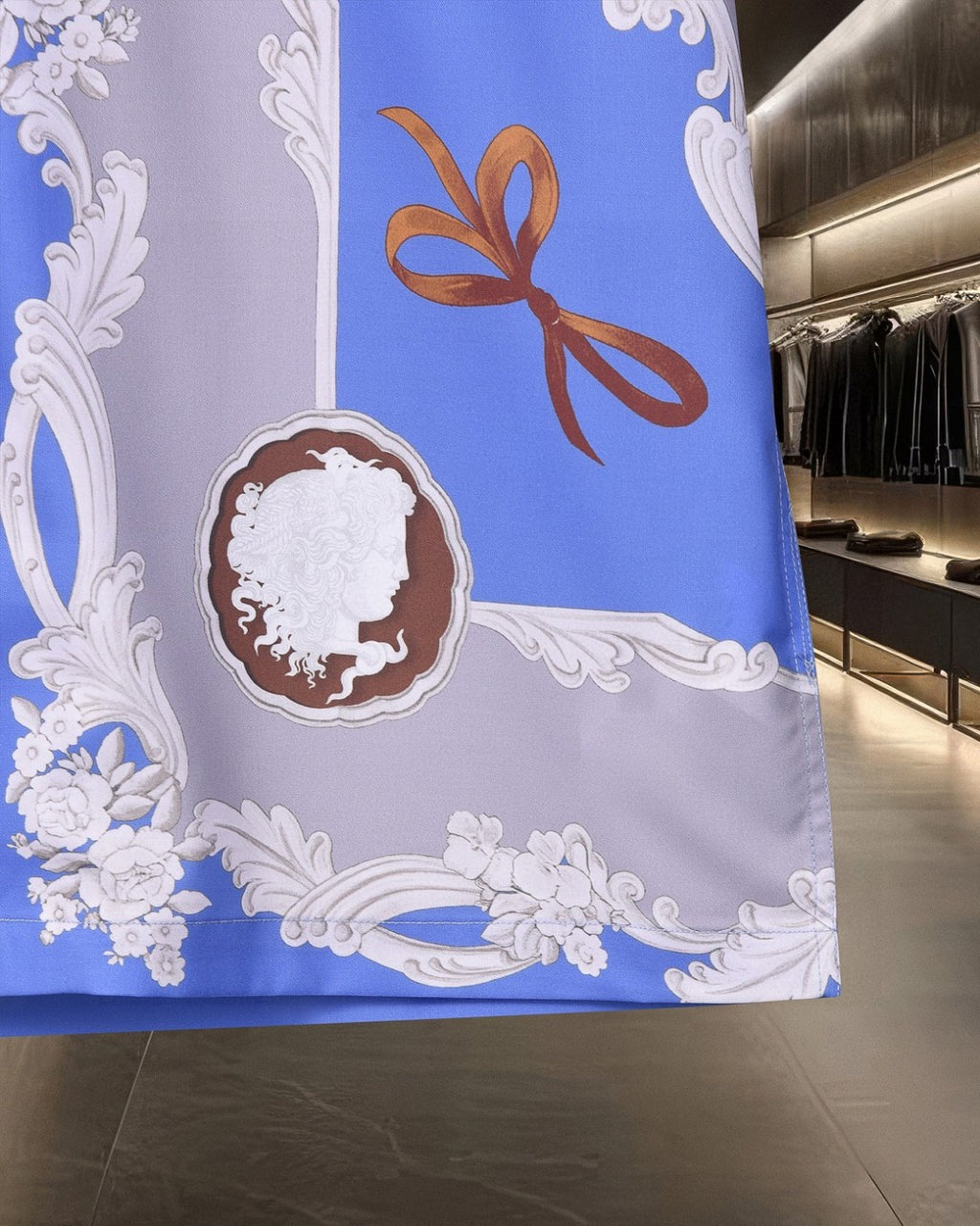 Patterned shirt fabric panel with blue, orange bow, and white ornate medallion