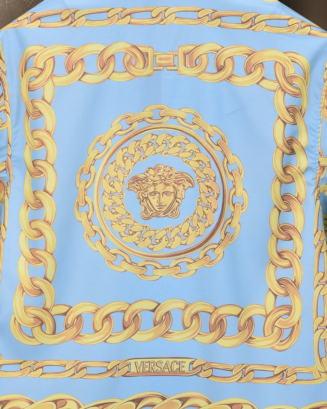 Versace shirt back center: light blue with gold chain border and Medusa crest