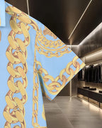 Versace short-sleeve shirt sleeve and cuff close-up, light blue with gold chain print