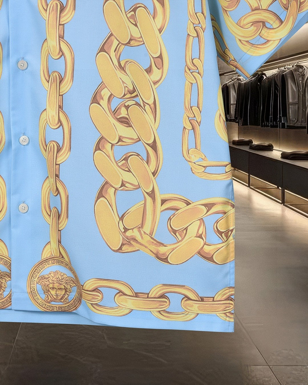 Light blue chain-print button-up shirt with gold links and front buttons