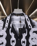 Versace black short-sleeve shirt with white chain print, collar view and button placket