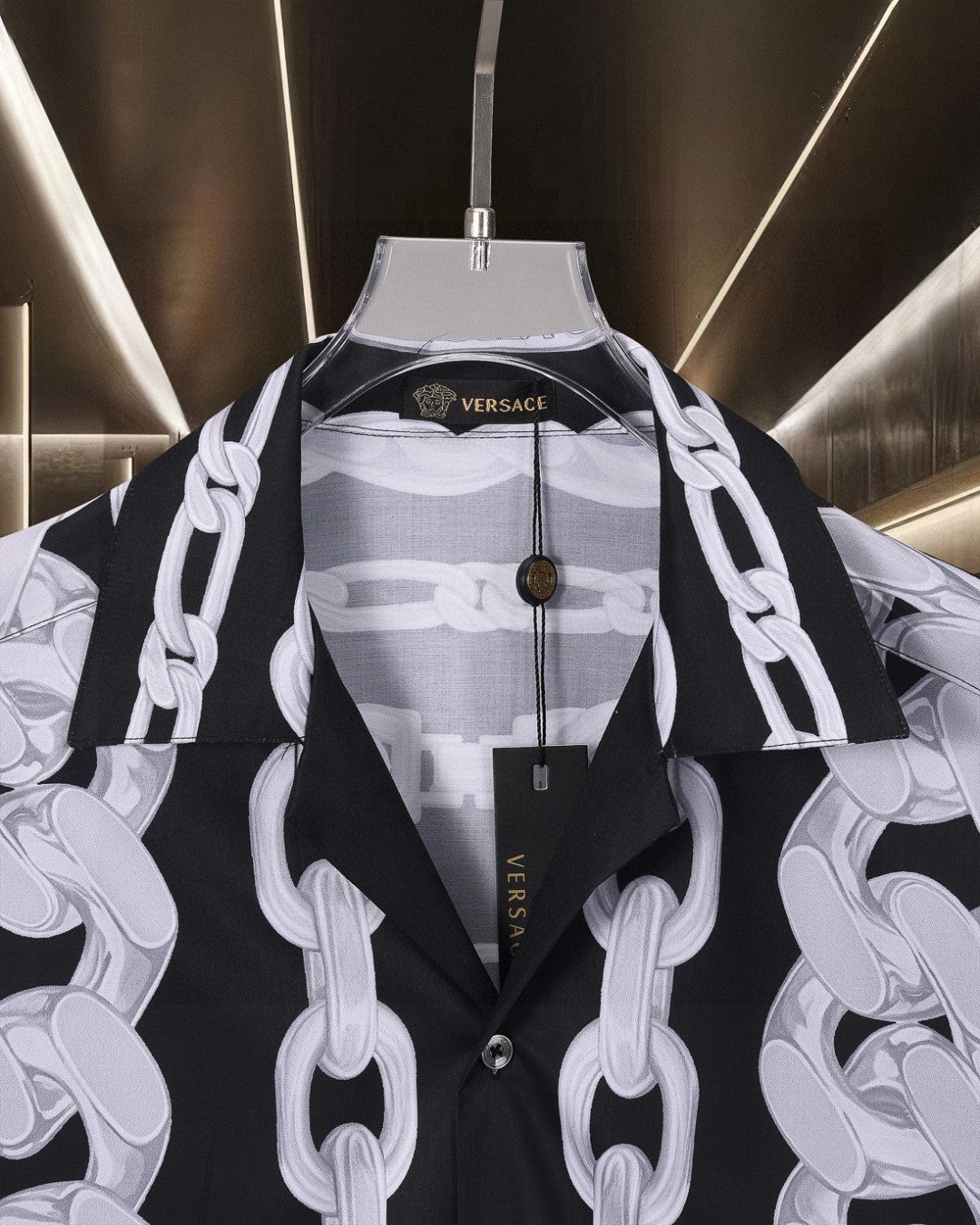 Versace black short-sleeve shirt with white chain print, collar view and button placket