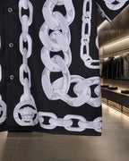 Black jacket with large white chain-link print and button front