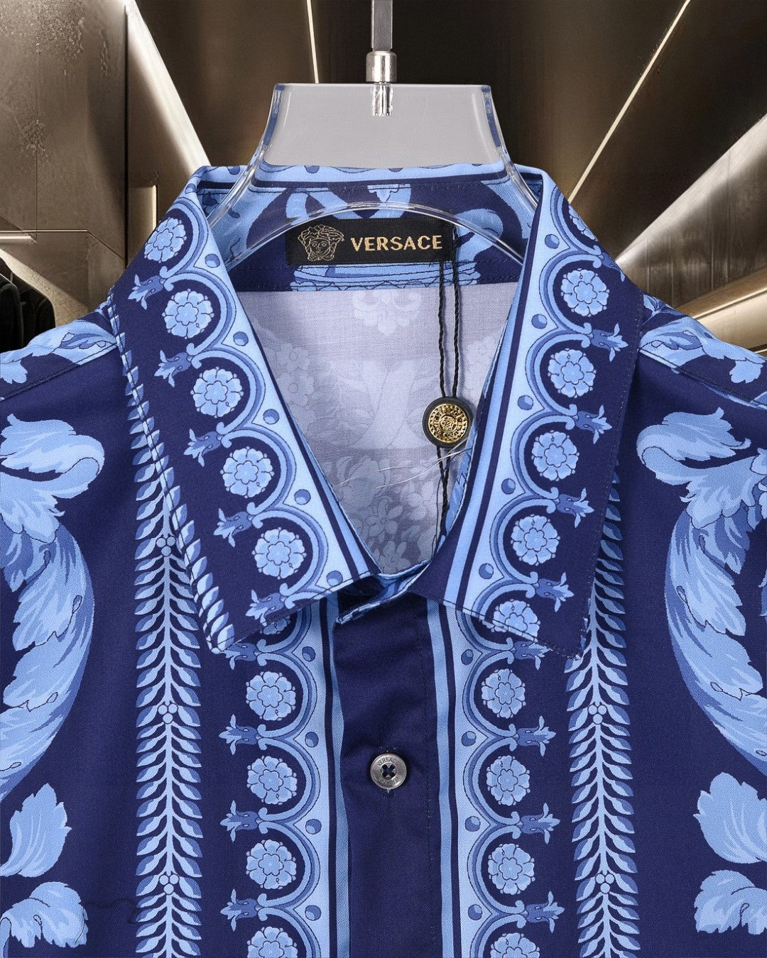 Versace blue short-sleeve shirt with button front, gold medallion, and baroque print