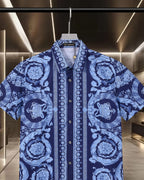 Blue short-sleeve shirt with ornate baroque floral and medallion pattern, button placket