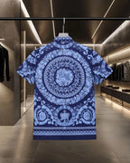 Blue short-sleeve shirt back with large circular medallion print and button placket