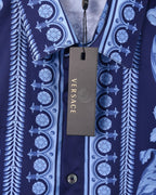 Versace blue shirt hanging tag over patterned fabric and buttoned center placket