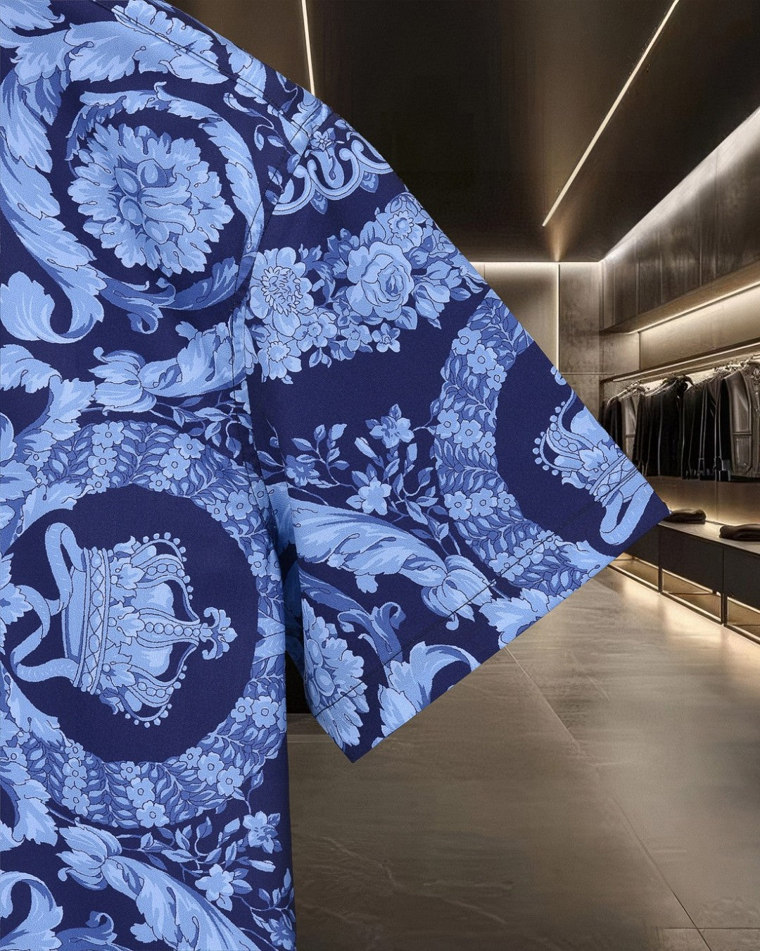 Blue short-sleeve shirt with floral and baroque scroll pattern across shoulder