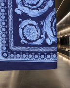 Versace blue patterned garment with ornate floral and border print