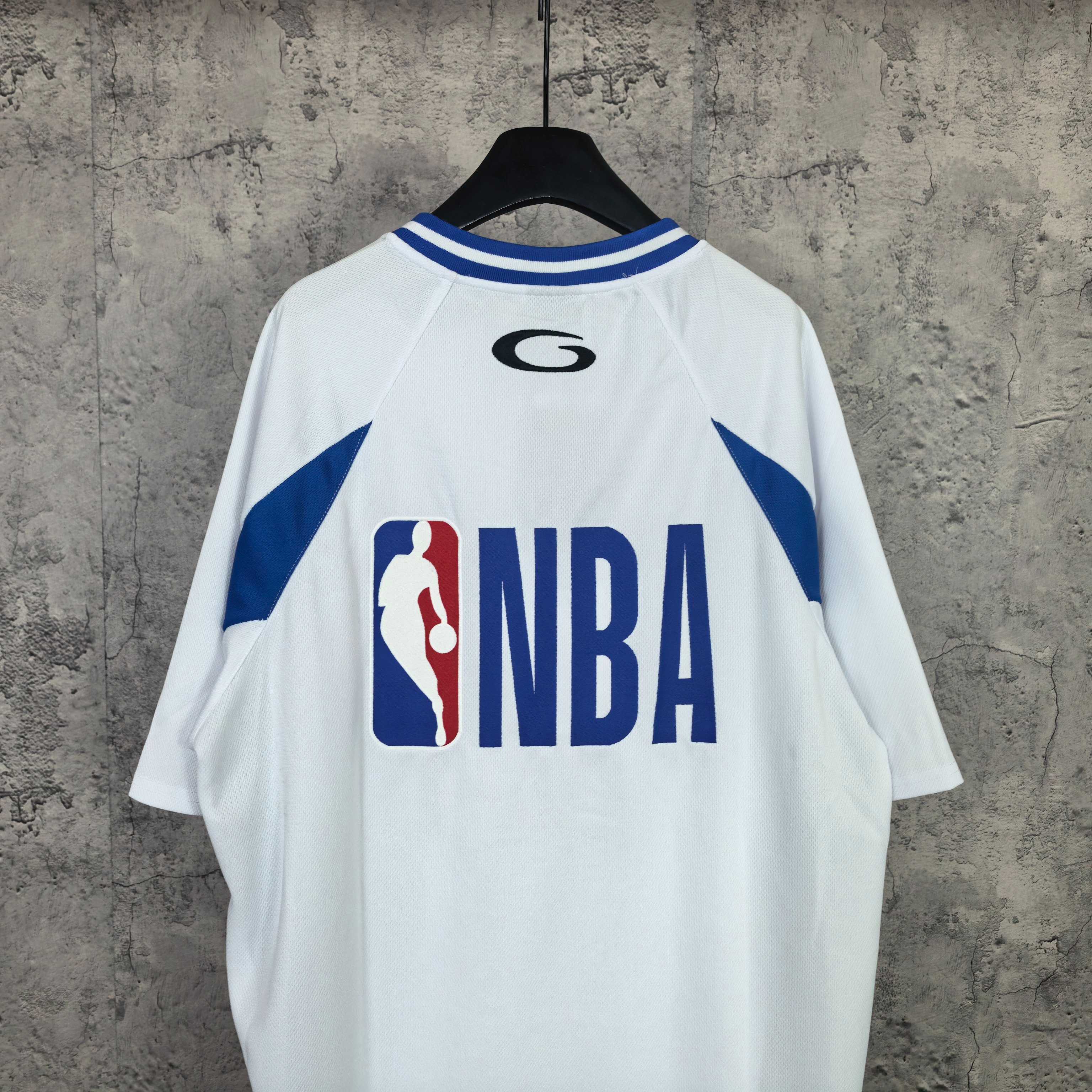 Balenciaga short-sleeve jersey, back view, white with blue side stripes, “NBA” graphic