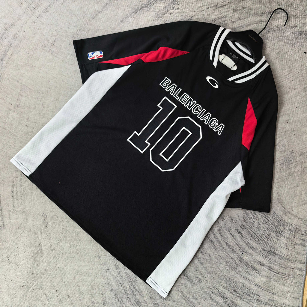 Black jersey laid flat with BALENCIAGA 10 print, white sleeves and red graphic panel
