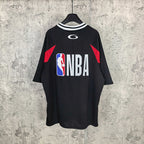 Black basketball jersey with NBA logo and red side panels, striped crew collar