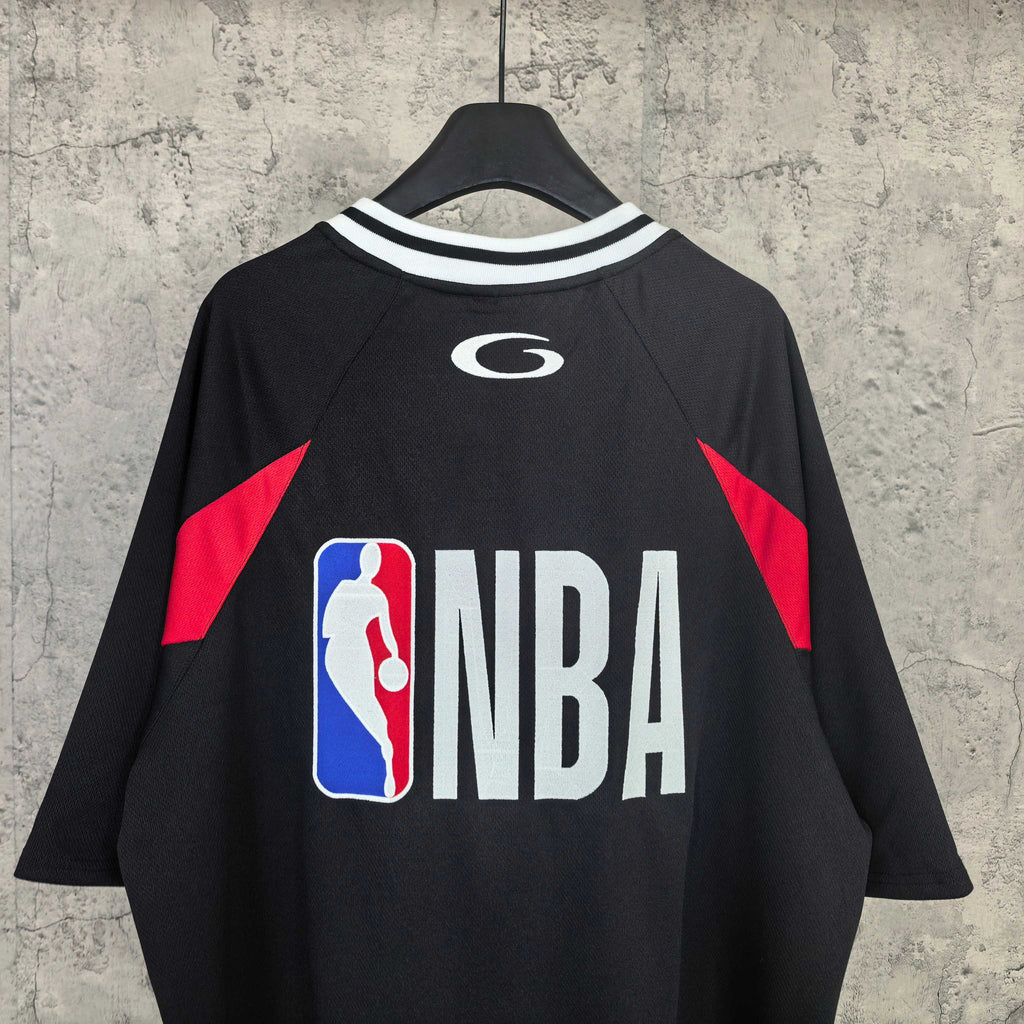 Black basketball jersey with NBA logo, red shoulder panels and striped collar trim