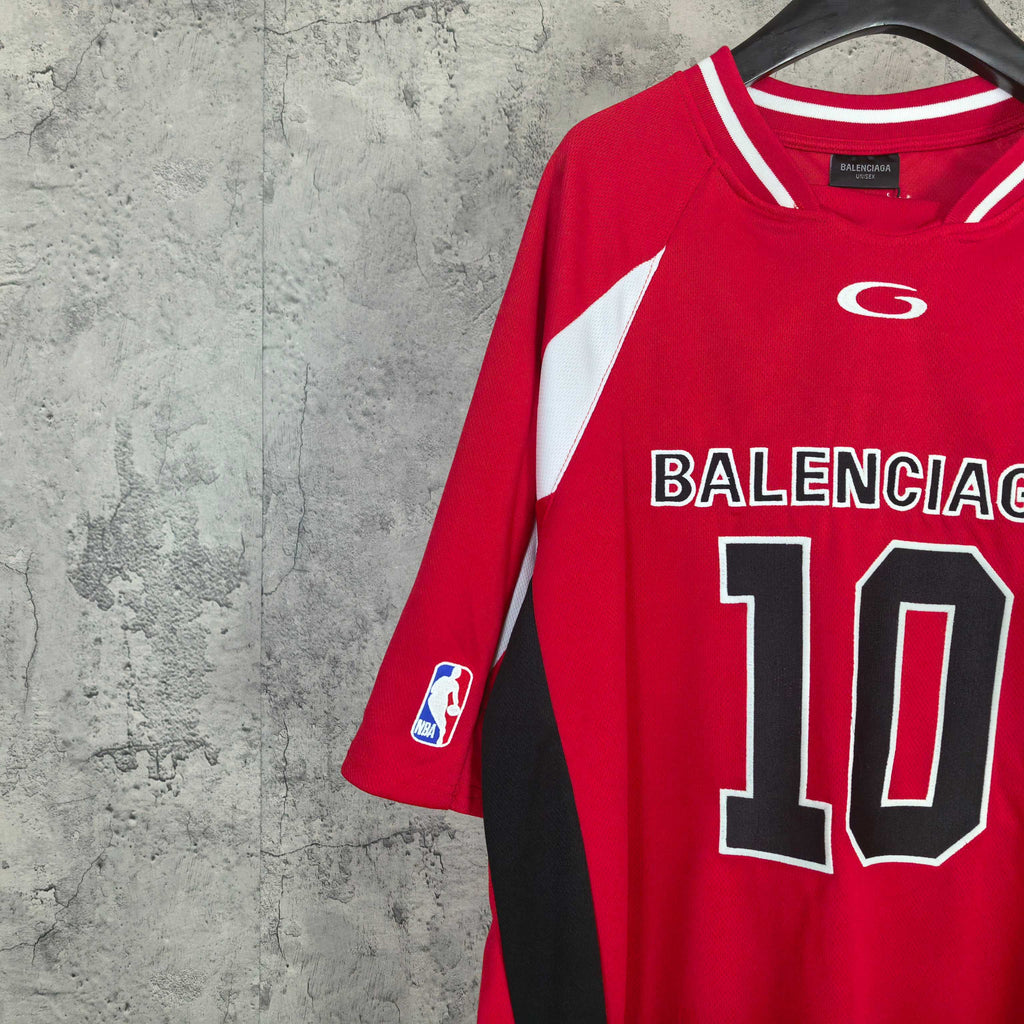 Red short-sleeve jersey angled on hanger with BALENCIAGA 10 front print