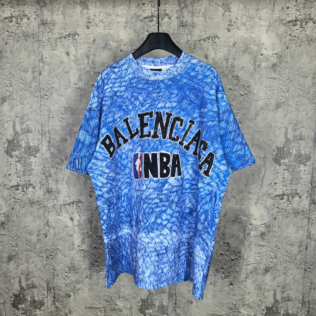 Blue short-sleeve graphic T-shirt with Balenciaga and NBA logo on chest.