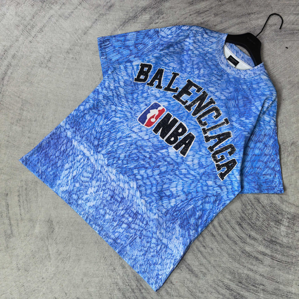 Blue short-sleeve T-shirt with large Balenciaga and NBA graphic on chest.