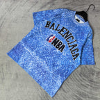 Blue short-sleeve T-shirt with large Balenciaga and NBA graphic on chest.