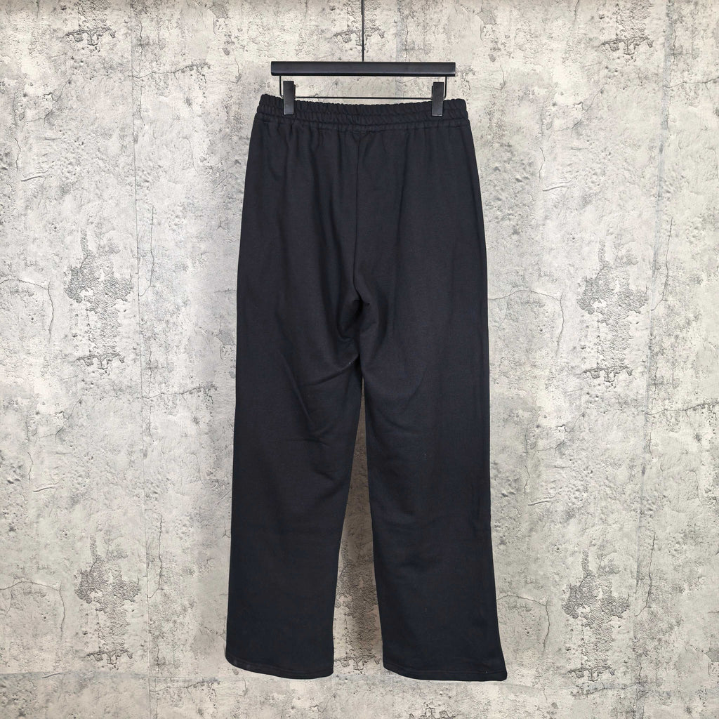Black track pants with elastic waistband, relaxed straight legs