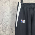 Dark pants with elastic waistband and NBA logo patch