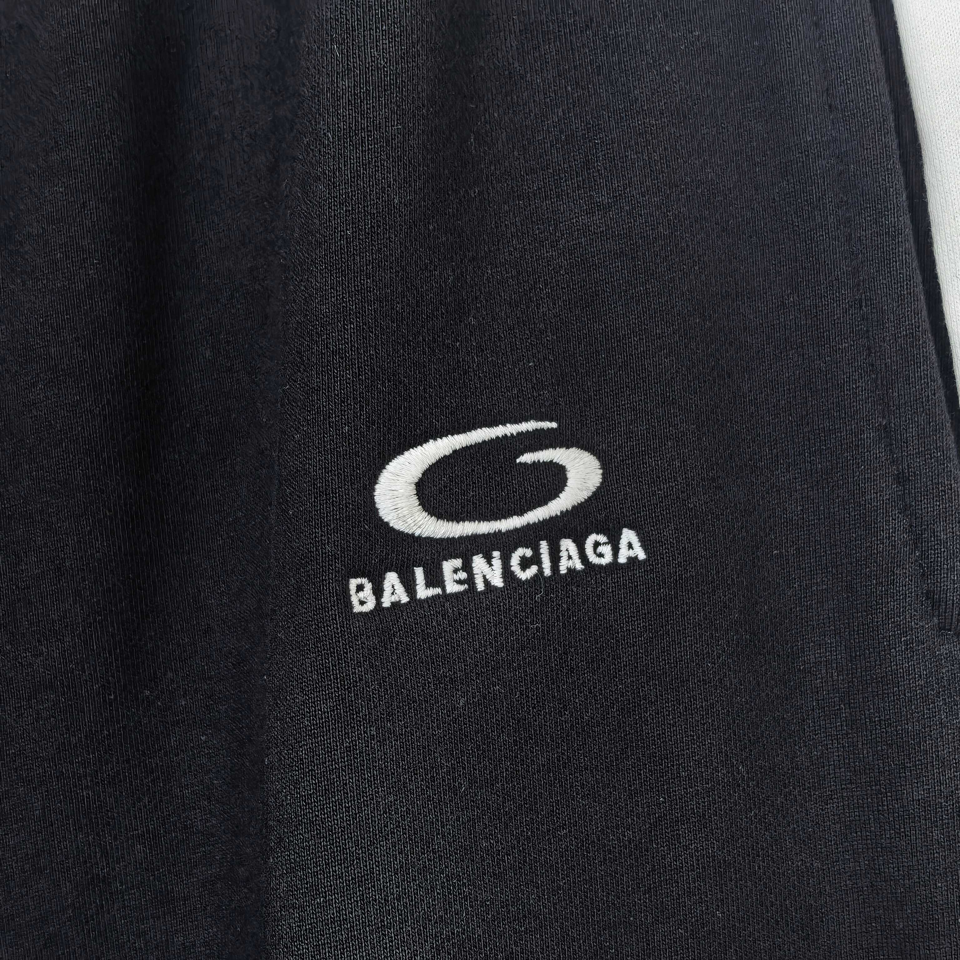 Close-up of Balenciaga logo on black track pants fabric