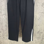 Black track pants with white side stripes