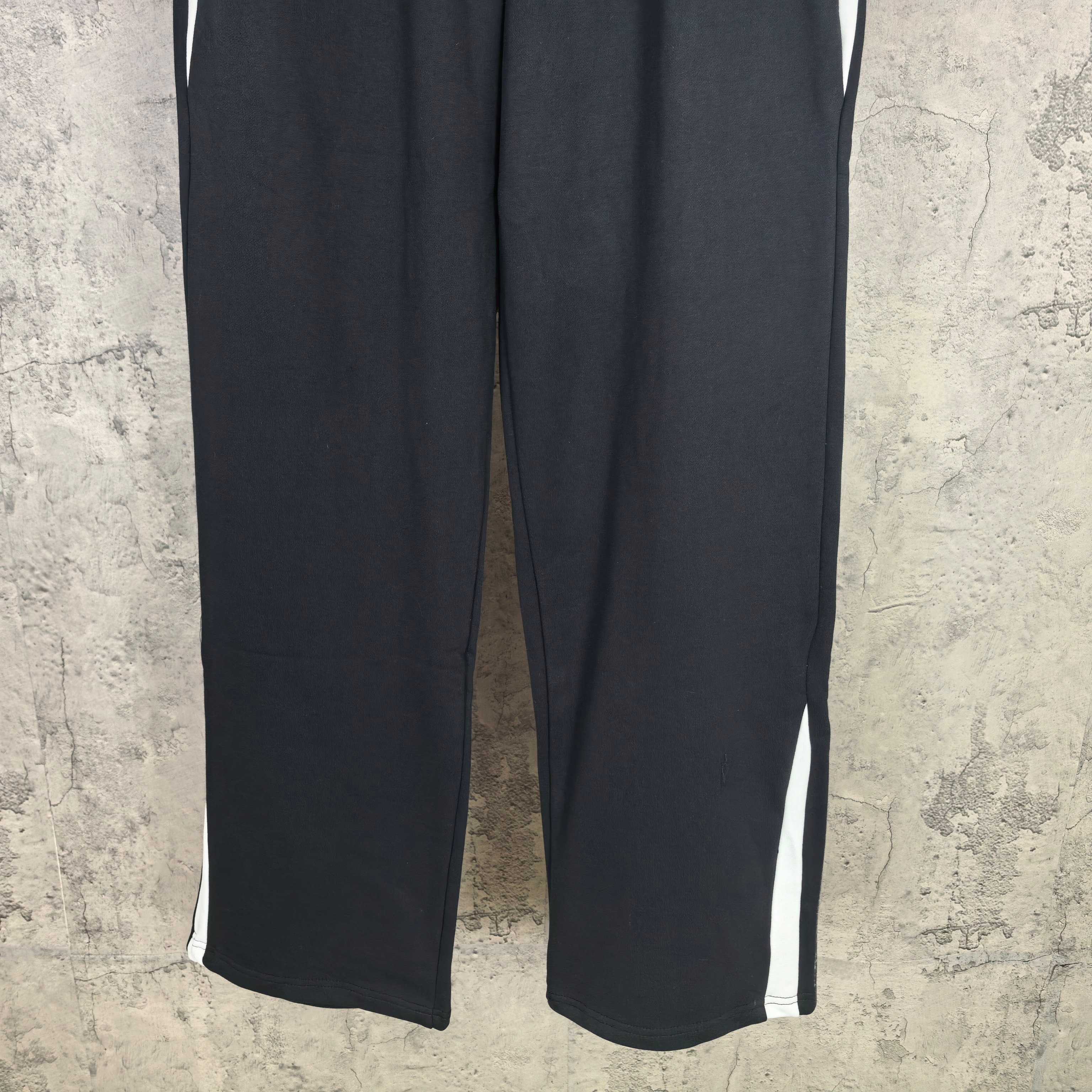 Dark wide-leg pants with white side stripes