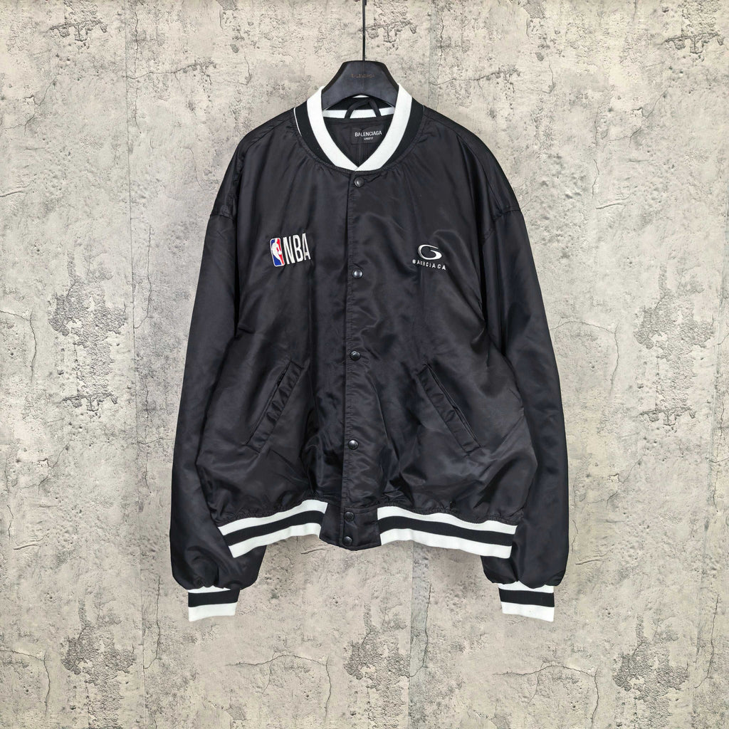 Black varsity bomber jacket with white striped ribbed cuffs and NBA patch