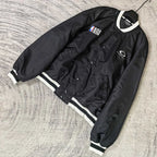 Black bomber jacket with NBA patch, snap front, and white striped cuffs
