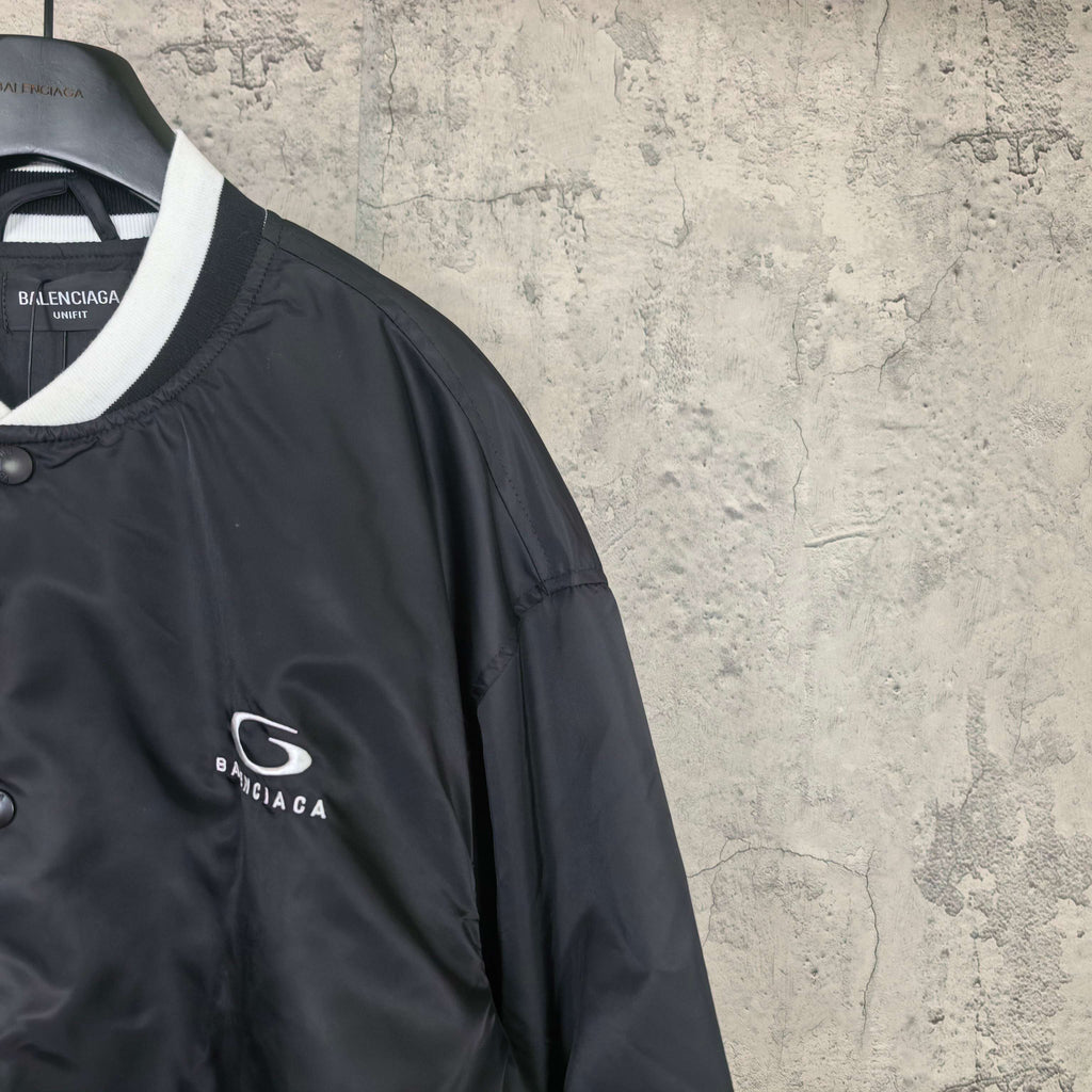 Black bomber jacket with Balenciaga logo patch on sleeve and white collar trim