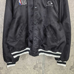 Black bomber jacket front with snap placket and white striped hem trim
