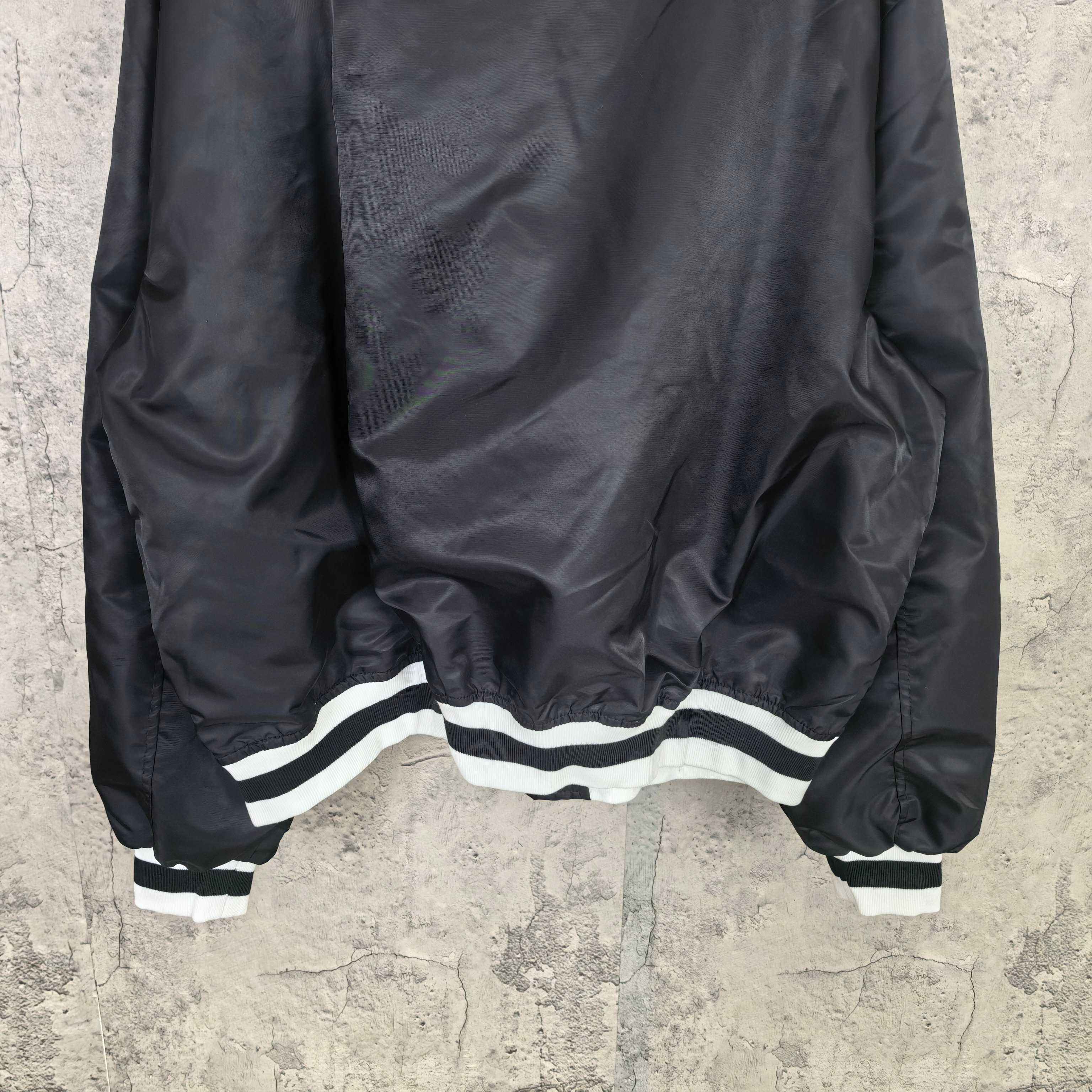 Balenciaga long jacket with white striped hem and cuffs, black fabric