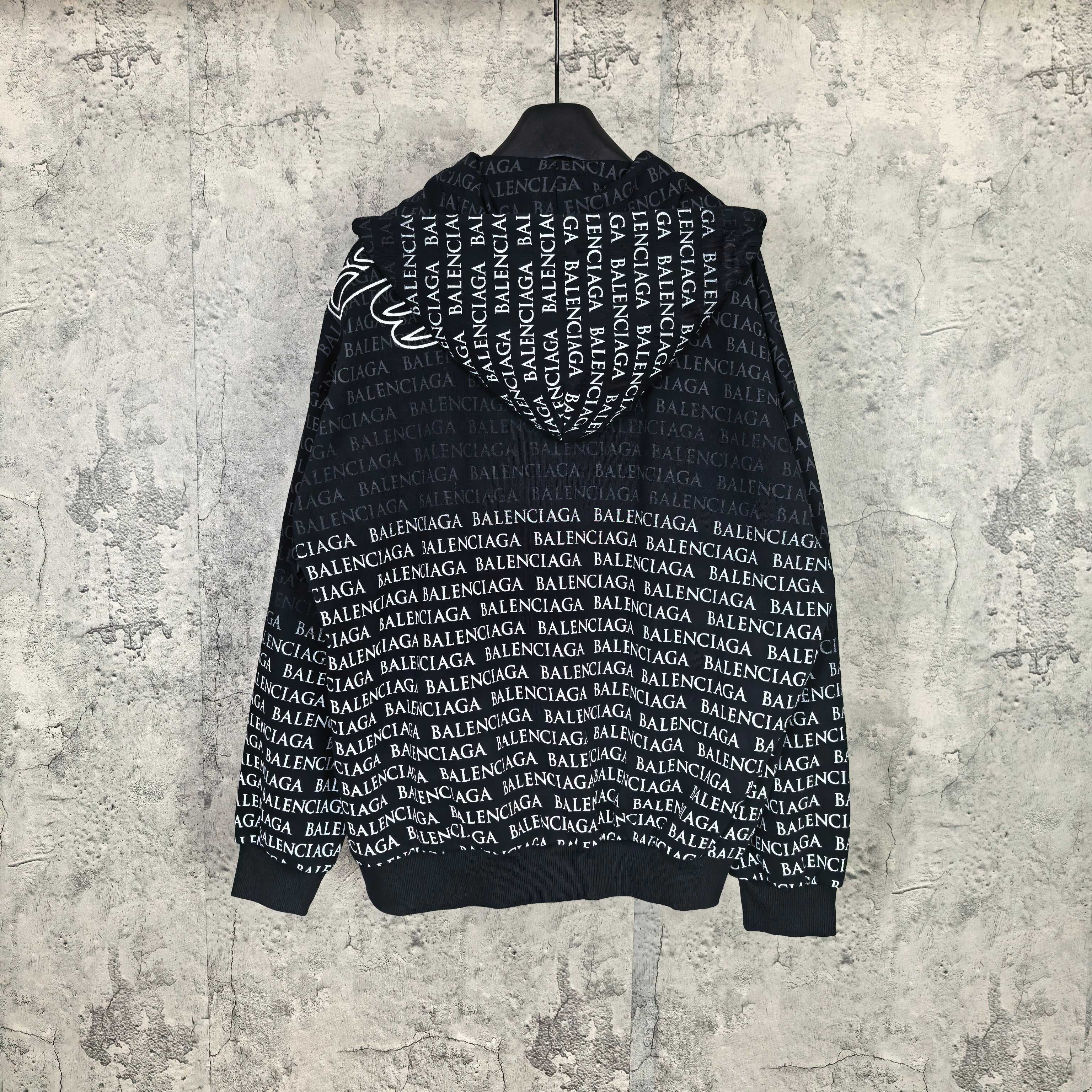 Balenciaga zip-up hoodie, black with allover repeating BALENCIAGA text; hood and zipper