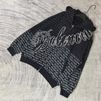 Folded dark zip hoodie set, showing Balenciaga text print and large white graphic detail.