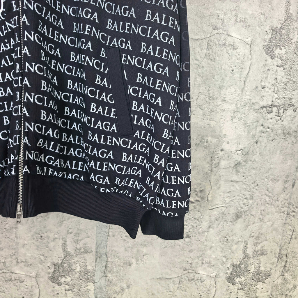 Balenciaga zip-up hoodie, black hem view with repeating BALENCIAGA text and white logo